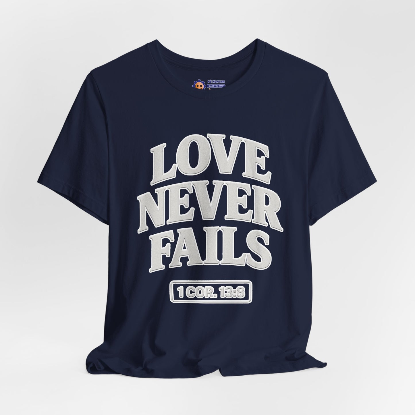Navy blue t-shirt with 'LOVE NEVER FAILS' text on a light gray background