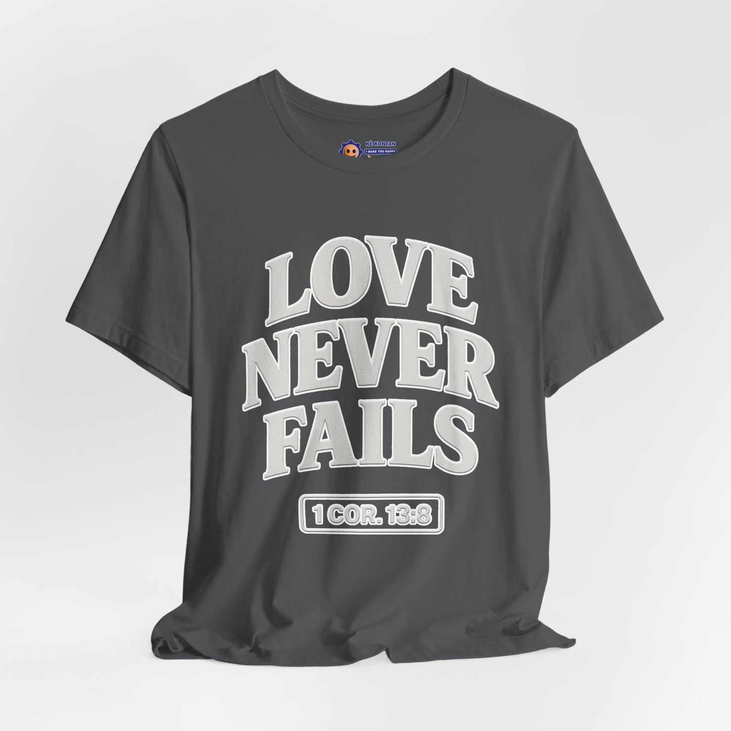 Gray t-shirt with 'LOVE NEVER FAILS' text on a light gray background