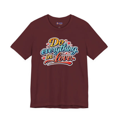 Maroon t-shirt with colorful text 'Do everything in love' on a white background