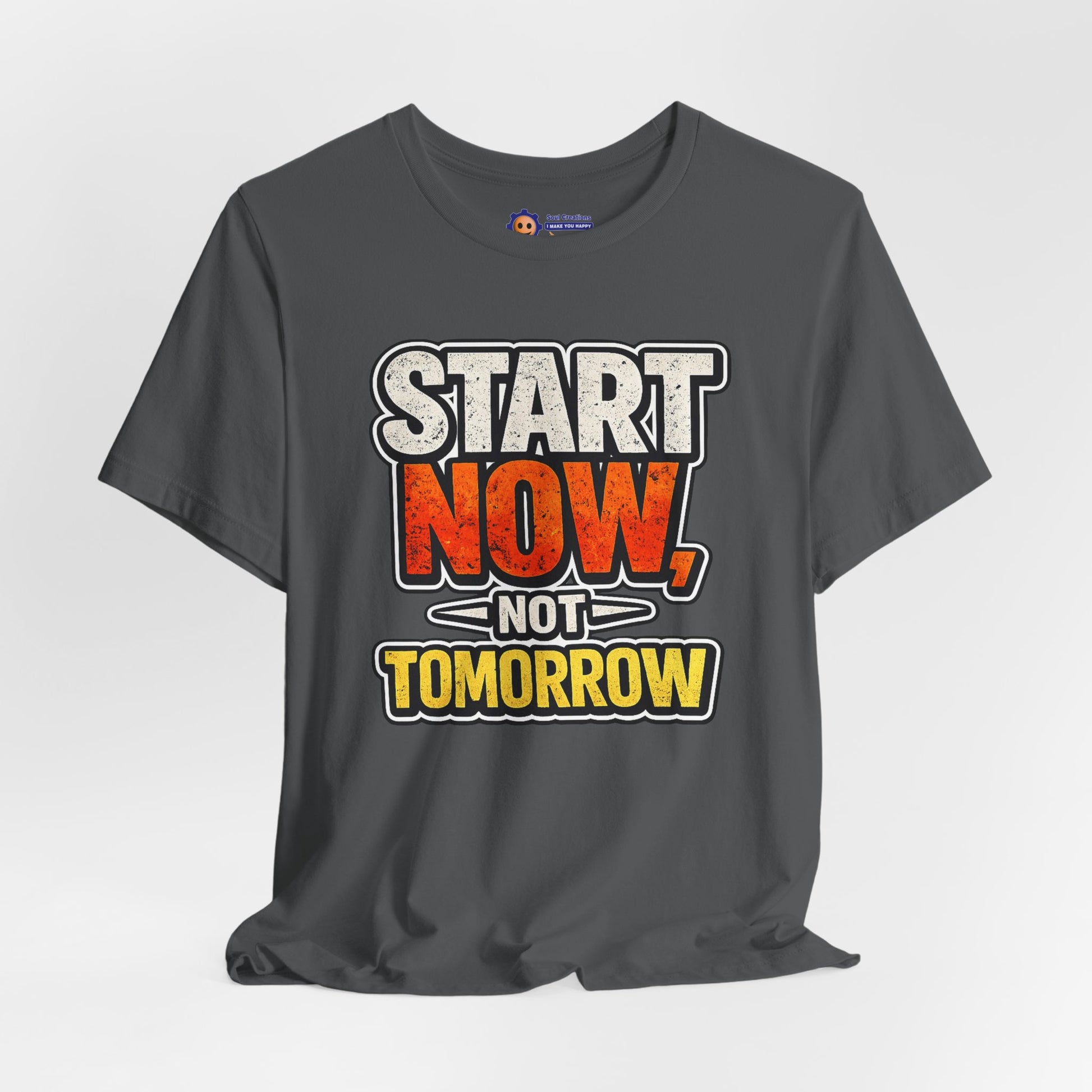 Gray t-shirt with motivational quote 'Start Now, Not Tomorrow' on a light gray background
