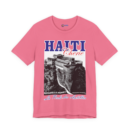 Pink t-shirt with Haiti-themed design featuring a castle and text on a white background